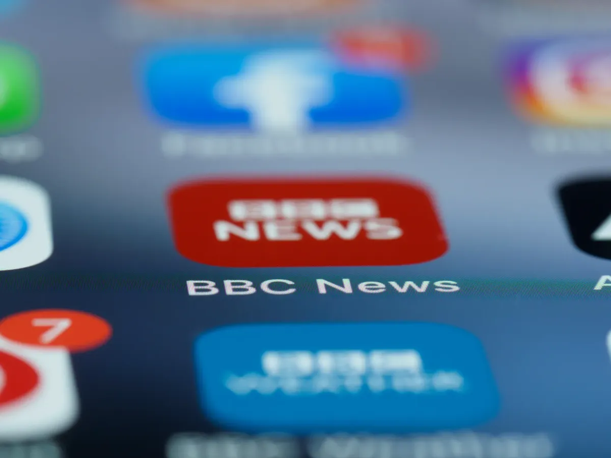 Macro shot of a smartphone screen displaying the BBC News app icon and notifications.
